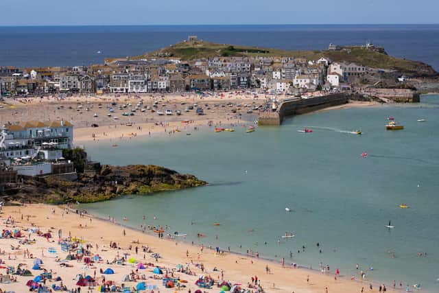 Visitors and holidaymakers enjoy the fine weather as they gather on the beaches and the harbour on August 4, 2014 in St Ives, Cornwall
