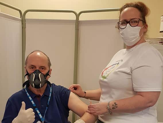 Steven Roy Gratrix receives his vaccine from Emma Seddon