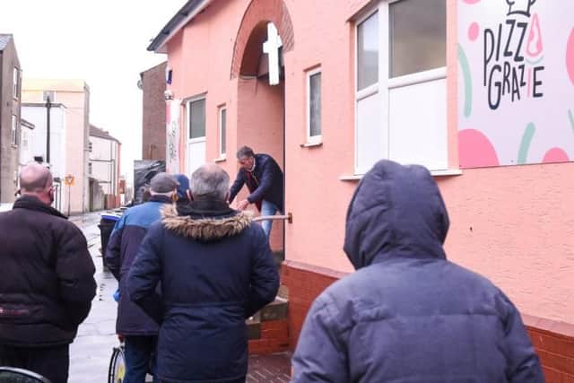 People queuing for food at the soup kitchen on Tuesday evening