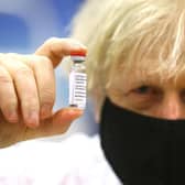 Prime Minister Boris Johnson holding a vial of the Oxford/Astra Zeneca Covid-19 vaccine on February 17, 2021 (Picture: Geoff Caddick/PA Wire)