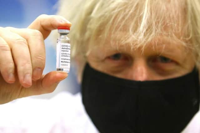 Prime Minister Boris Johnson holding a vial of the Oxford/Astra Zeneca Covid-19 vaccine on February 17, 2021 (Picture: Geoff Caddick/PA Wire)