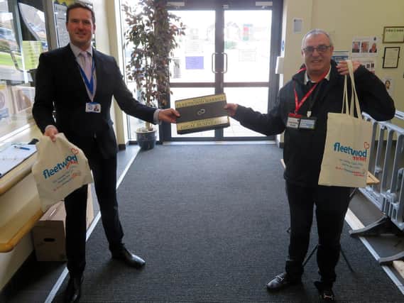 Head of School Improvement, Nigel Whittle, receiving the laptops from Colin Hind from the Fleetwood Market Forum.