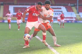 Ellis Simms battles for the ball with Charlton defender Akin Famewo