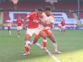 Ellis Simms battles for the ball with Charlton defender Akin Famewo