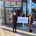 Hayley Bielby, from Alexander Grace Law, presenting a cheque to Lauren Codling, from Trinity Hospice, following Wills Week