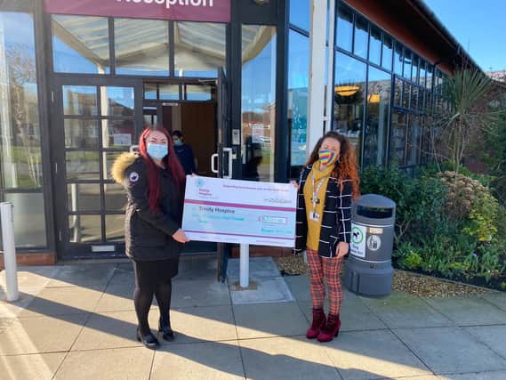 Hayley Bielby, from Alexander Grace Law, presenting a cheque to Lauren Codling, from Trinity Hospice, following Wills Week