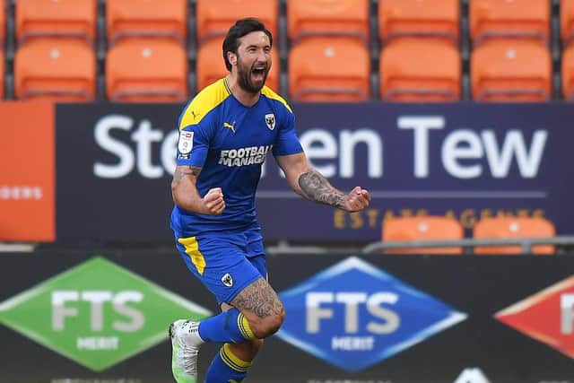 Ollie Palmer celebrates his stoppage-time equaliser for AFC Wimbledon