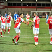 Striker Kyle Vassell is congratulated by Fleetwood teammate James Hill on his matchwinning penalty against Gillingham