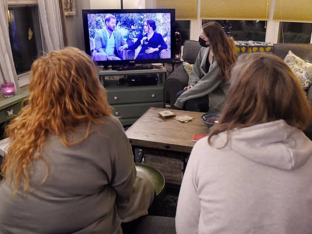 People watching a televised conversation between Prince Harry with his wife Meghan Markle and US host Oprah Winfrey