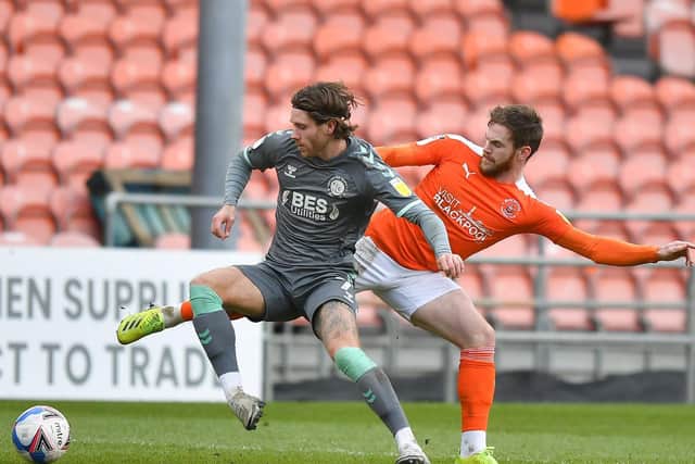 Wes Burns tries to escape the attentions of Blackpool's Ollie Turton