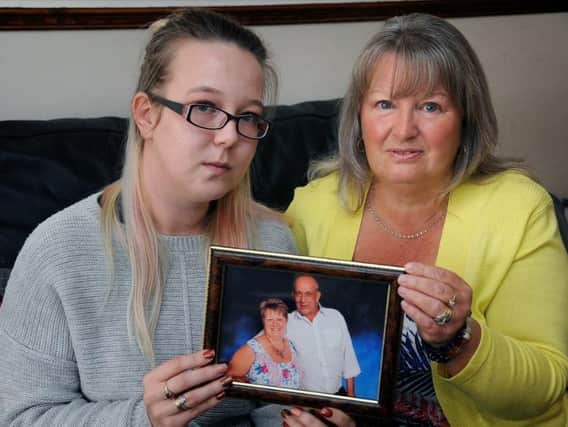 Rebecca and Christine Birch with a picture of Paul, who died as a result of a contaminated blood transfusion