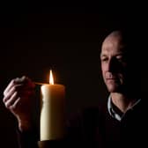 Dr Jason Cupitt, who is in charge of Blackpool Victoria Hospital's Covid intensive care unit, lights a candle in the hospital's chapel to remember the pandemic's victims (Picture: Dan Martino for JPIMedia)