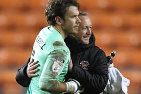 Neil Critchley embraces Chris Maxwell at the final whistle