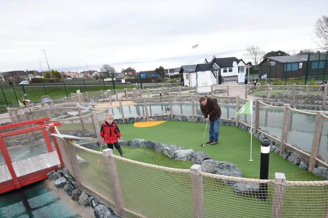 Damian Stubbs and son Connor playing on the adventure golf course at Fairhaven Lake