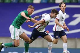 Dan Ballard (left) in action for Northern Ireland against the USA, the first of two international starts in four days for the Blackpool defender