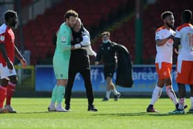 Neil Critchley embraces Chris Maxwell at the full-time whistle
