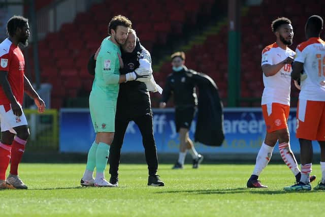 Neil Critchley embraces Chris Maxwell at the full-time whistle