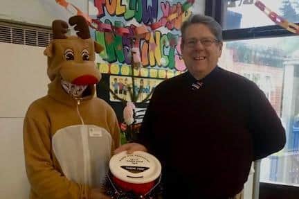 Rudolph from the Knott End and Preesall Santa Tour with headteacher of  Carter's Charity Primary School in Preesall, Brendan Hassett.
The school received a donation of £150