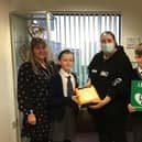 Sharon Cliff (left), acting head of Larkholme Primary School, with school parent Helen Crane (centre), Debbie Atkinson, chairman of governors and two pupils, as Helen presents a defibrillator to the school.