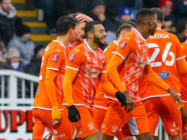 The Blackpool players celebrate Keshi Anderson's goal.