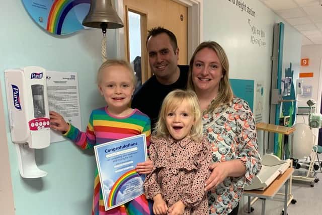 Lydia rings the bell at the hospital to mark the day her treatment finished