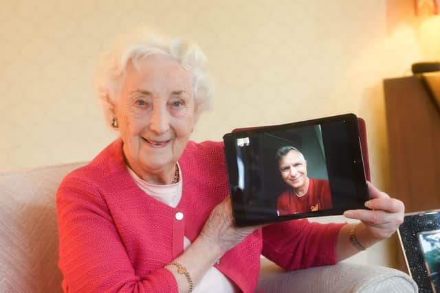 Doreen Connolly at her home in St Annes, with her son-in-law Phill Christofaro on the screen of her laptop