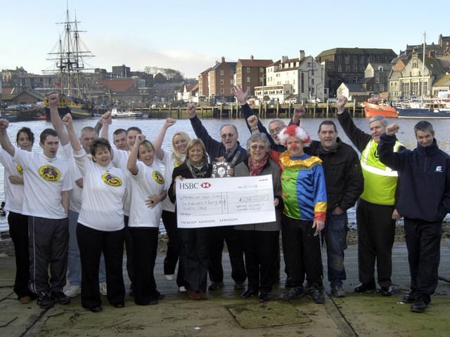 Joan Forbes of the Scarborough and district fundraising group of Macmillan Cancer Support receives a cheque from Whitby Lions, with staff members from Mr Chips.
