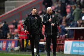 Fleetwood boss Stephen Crainey (right) had plenty to discuss with fellow coach Barry Nicholson after the defeat at Charlton