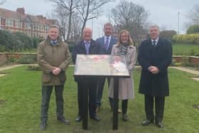 Family, friends and Wyre Council leader, Coun David Henderson, gather around the memorial