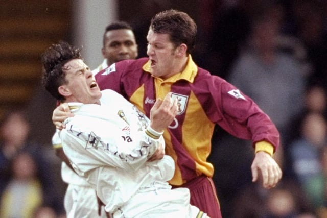 Bradford City's Dean Windass takes his frustrations out on Ian Harte during the Premiership clash at Valley Parade in March 2000. A brace from Michael Bridges won the game for Leeds.