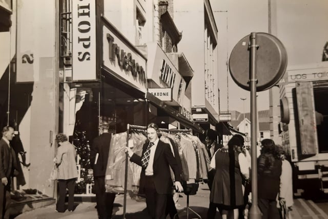 The new pedestrian 'precinct' was causing difficulties for deliveries to shops outside the allotted time in this 1971 photo. The caption reads 'sometimes racks of dresses and suits have to be trundled along the pavement through the crowds'