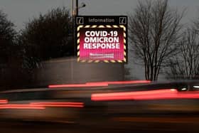 Traffic passes a digital board displaying Covid-19 Omicron information on the outskirts of Blackpool.