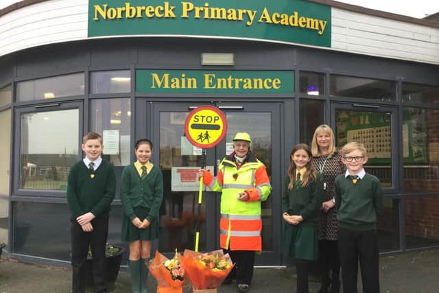 Members of the junior leadership team at Norbreck Primary Academy, Norbreck Road, Blackpool, with school crossing patrol officer Lesley Owen, who has been the school’s lollipop lady for 40 years
