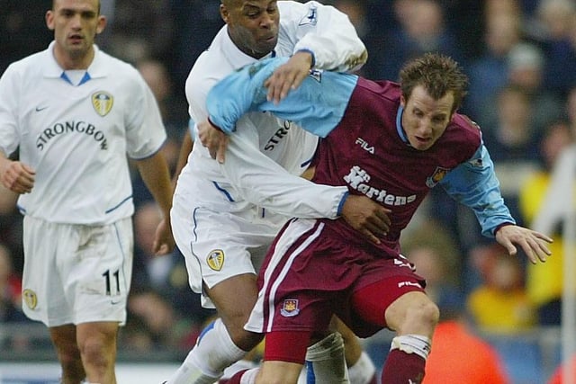 Lee Bowyer is held back by Michael Duberry.