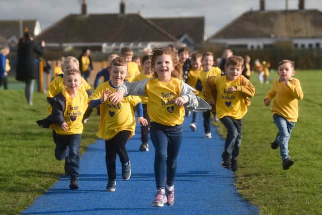 Pupils from Anchorsholme Academy dress in the school colours and run around the track to raise money for Isabelle Grundy