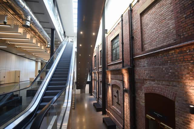 Escalators leading to the top floor of the new Winter Gardens conference centre. The original wall for the Empress Ballroom.