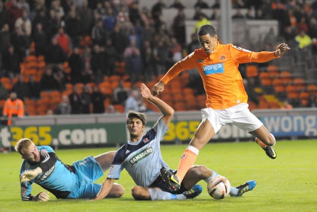 Tom Ince rounds the keeper to slot home Blackpool's third goal