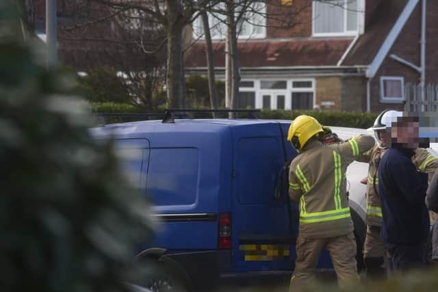 Police have tasked fire crews with forcing entry into a blue van parked near the scene