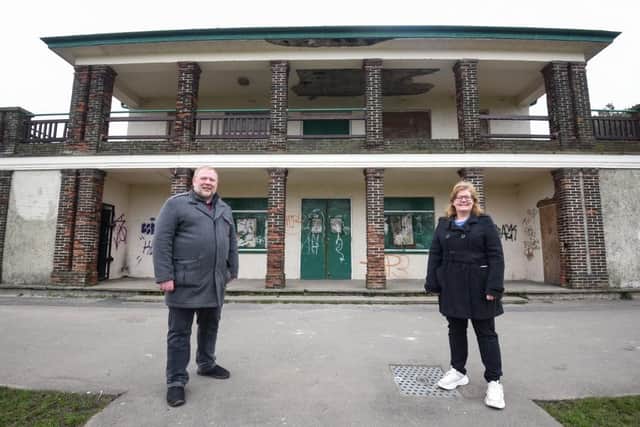 Councillors Andrew Stansfield and Debbie Coleman outside the rundown tennis pavilion