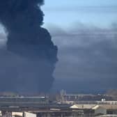 Black smoke rises from a military airport in Chuguyev near Kharkiv on February 24, 2022. - Russian President Vladimir Putin announced a military operation in Ukraine today with explosions heard soon after across the country and its foreign minister warning a "full-scale invasion" was underway.