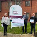 Nigel Dunnington centre hands over the money raised to Trinity Hospice