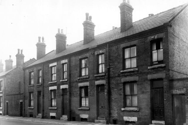 Even-numbered back-to-back houses on Bower Road in January 1961. An outside toilet block stands on either edge.