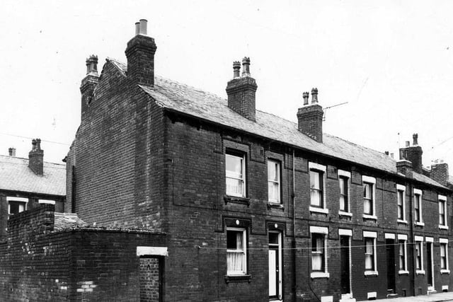 This is Ashton Terrace in August 1963. On the left is access to Windsor Place with a yard on the right, originally built to house the shared outside toilet.