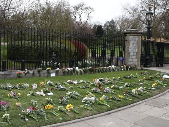 Flowers left by Cambridge Gate at Windsor Castle, Berkshire, following the announcement of the death of the Duke of Edinburgh at the age of 99. Picture date: Saturday April 10, 2021. Picture: Gareth Fuller/PA Wire/PA Images