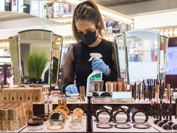 A John Lewis works cleans the Charlotte Tilbury counter at a Peter Jones store as they prepare for reopening on Monday. Picture: Kirsty O'Connor/Press Association