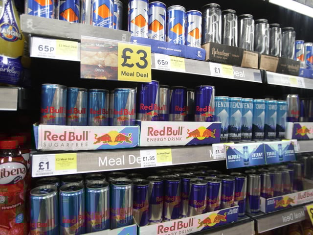 Shelves of energy drinks on sale.