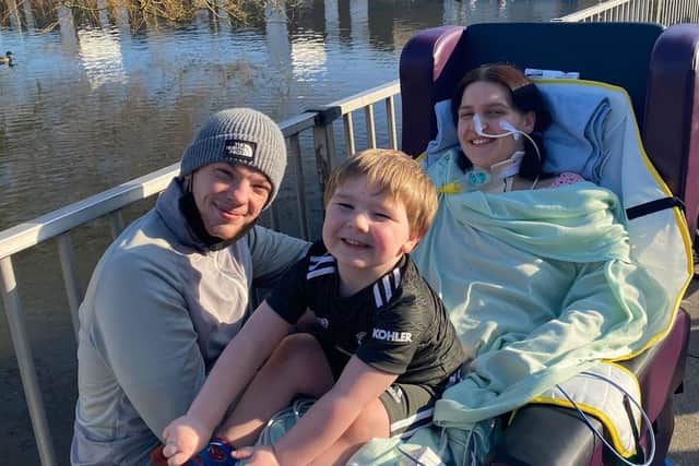 Jess Cook outside Royal Preston Hospital with partner Jayson Drake and their son Oscar