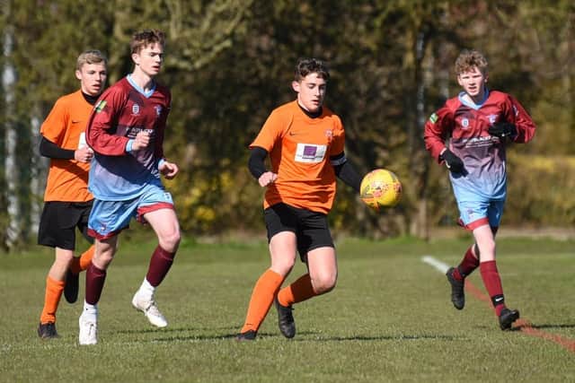 Under-16s action between Poulton Town (in orange) and Layton Junior Clarets