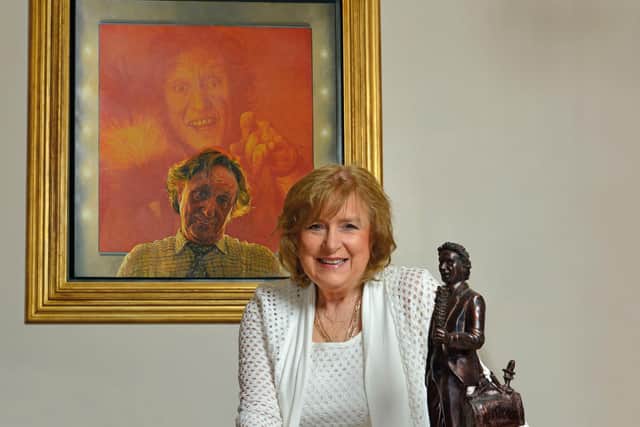 Lady Anne with Painting of Sir Ken Dodd by David Cobley. Photo: Ron Davies