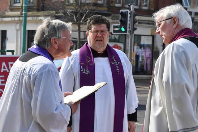 Father John Hall (centre) with fellow members of the clergy